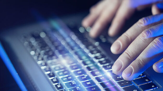 Close-up of male hands and laptop