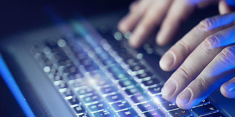 Close-up of male hands and laptop